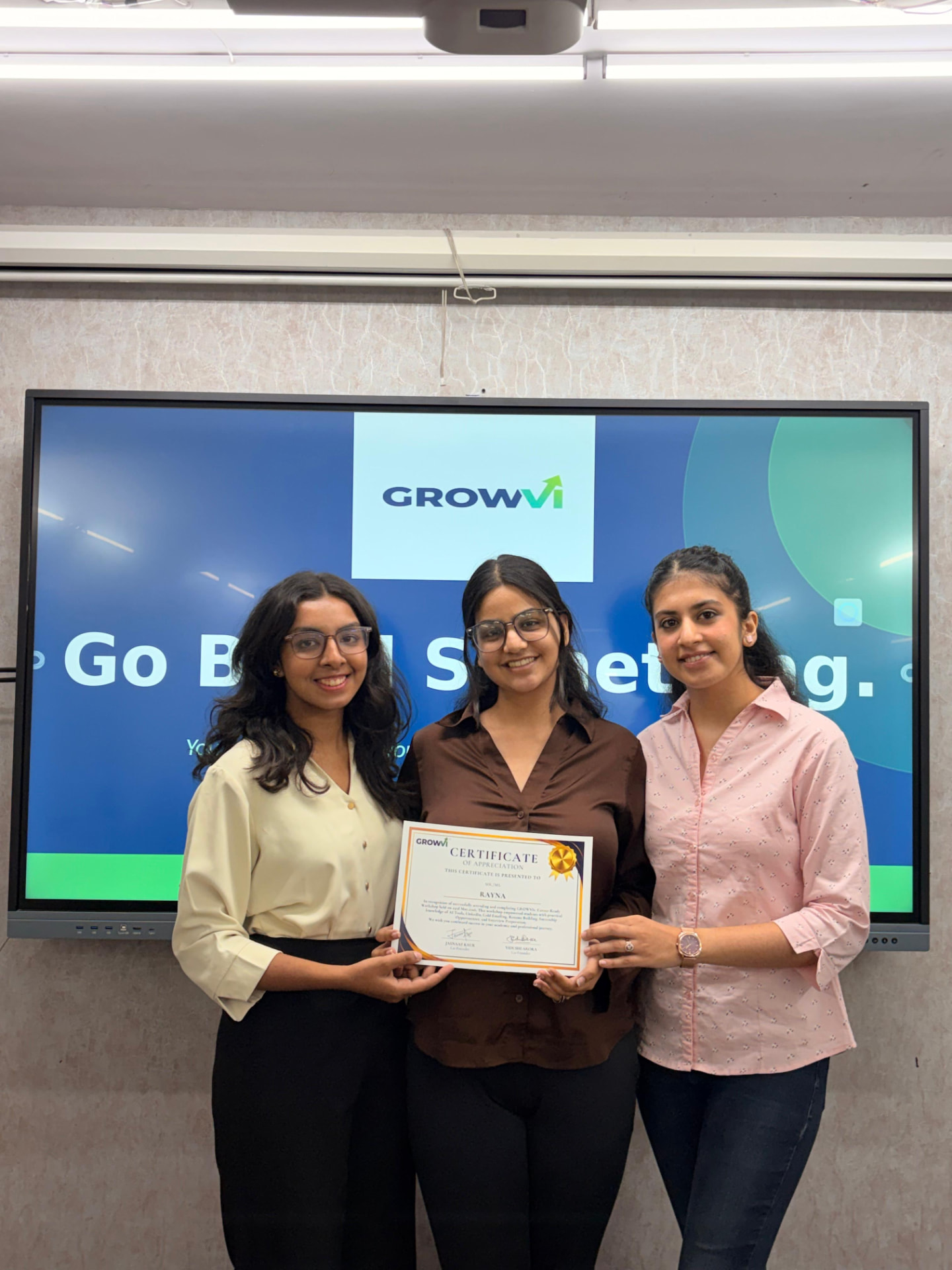 GROWVI founders presenting a certificate to a student
