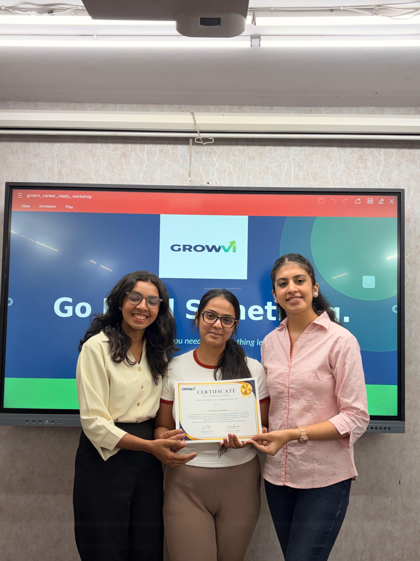 A student receiving a GROWVI certificate of appreciation